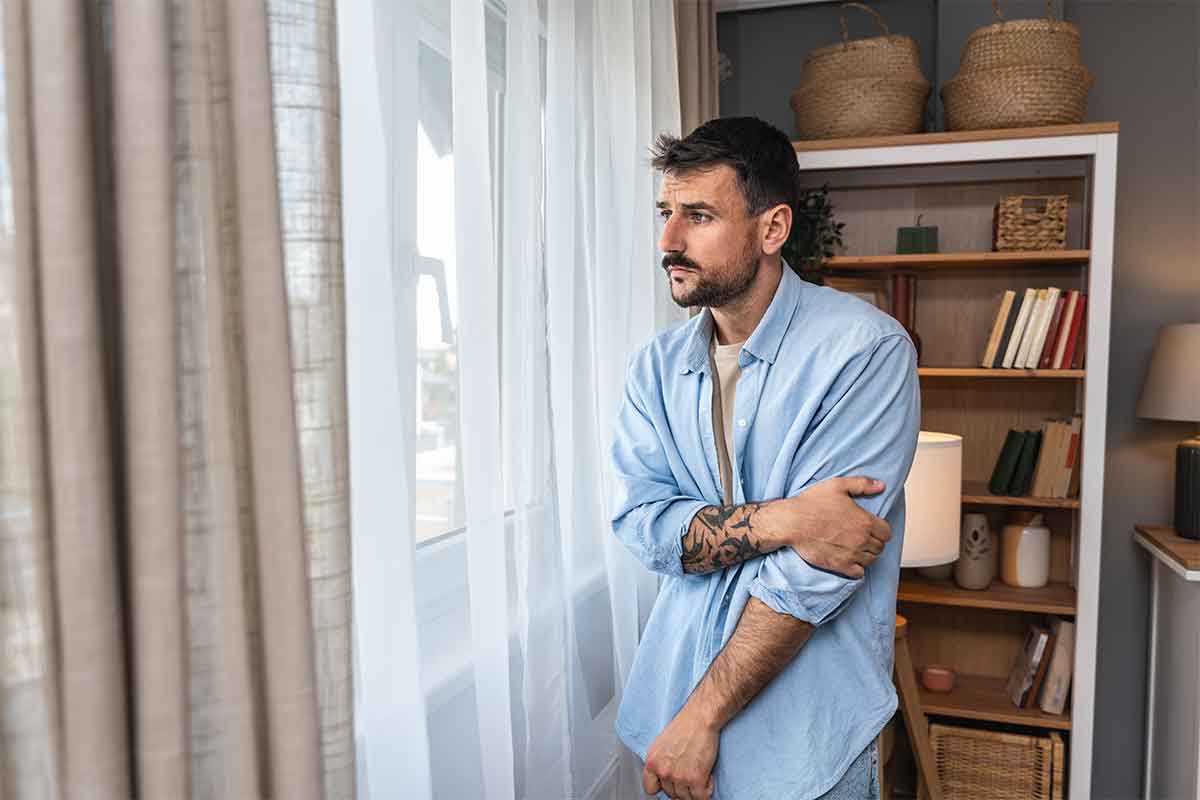 Man reflecting during a therapy session while weighing PHP versus IOP mental health care options