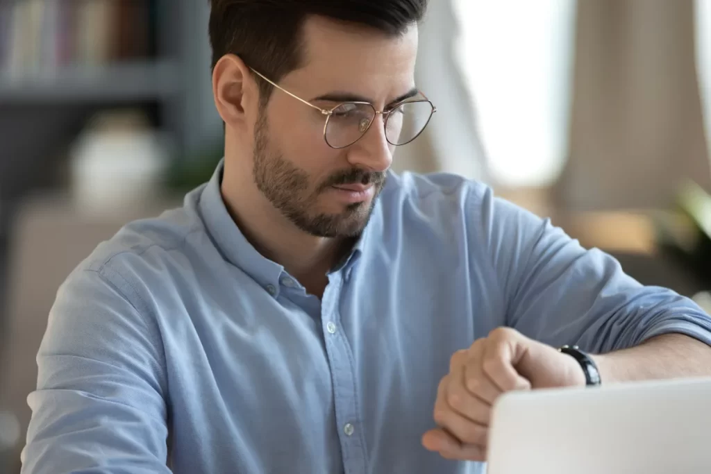 Professional checking a planner to schedule evening IOP sessions around a full-time work day
