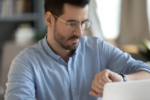 Professional checking a planner to schedule evening IOP sessions around a full-time work day