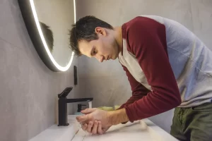Anxious man washing his hands again, illustrating the line between OCD and being careful